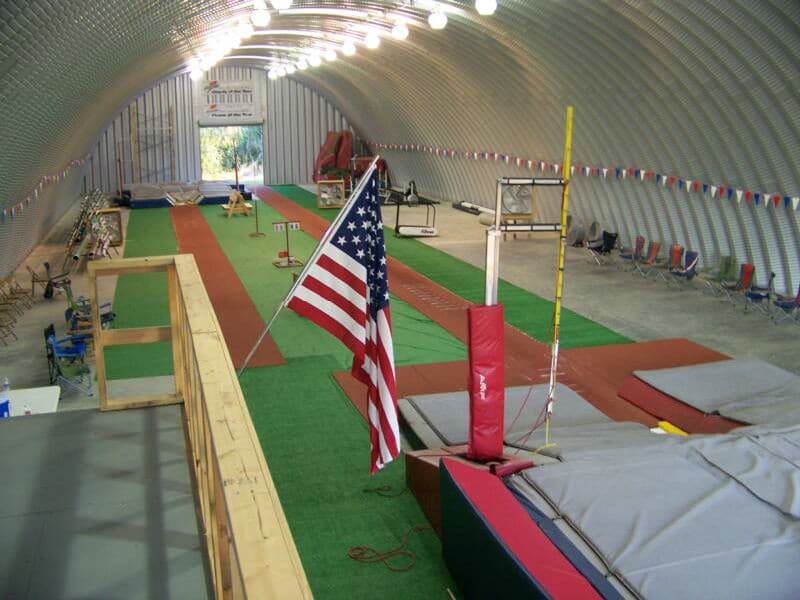 inside quonset hut pole vaulting facility with equipment and american flag