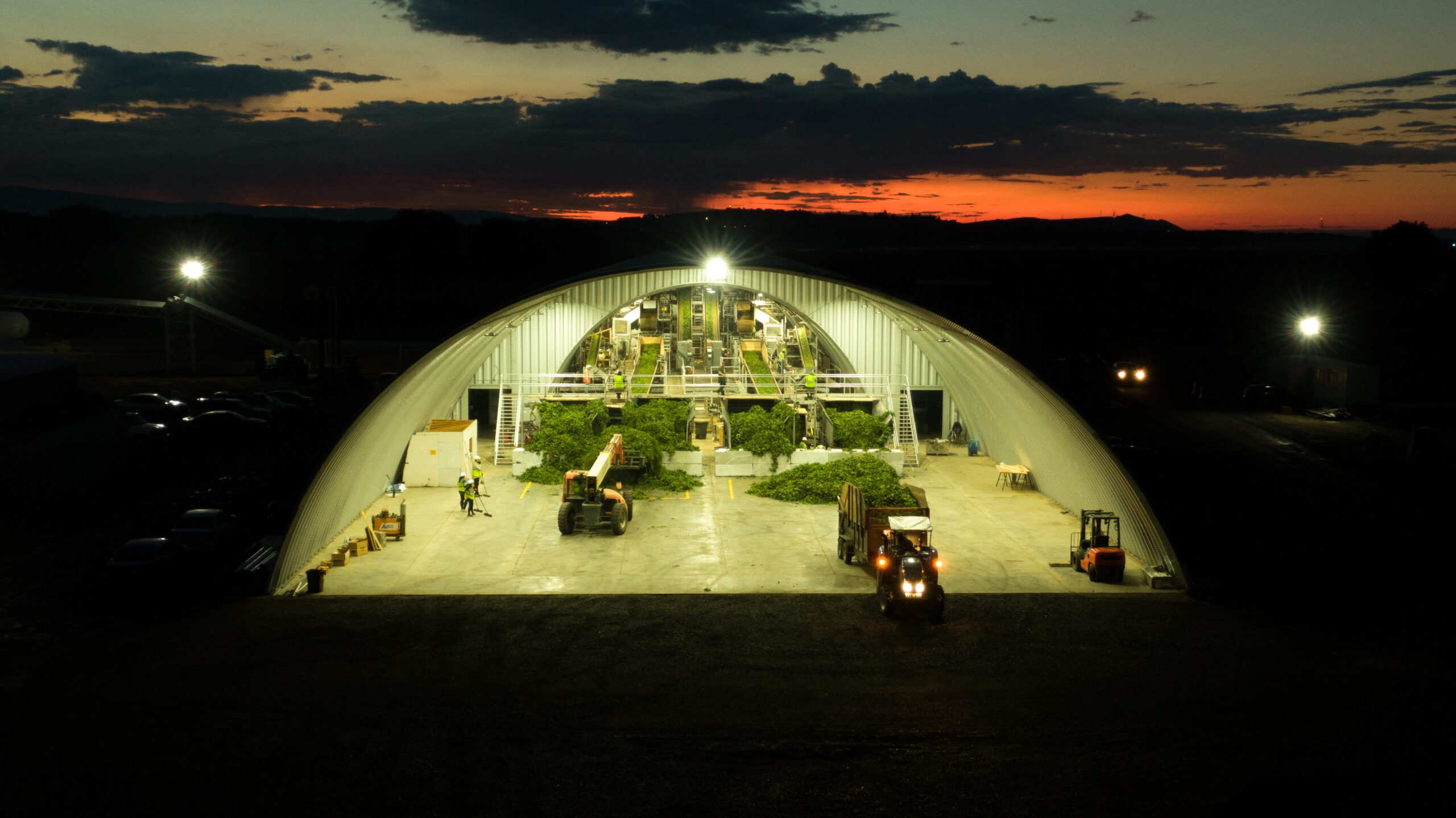 steel quonset hut processing facility with hops and other equipment