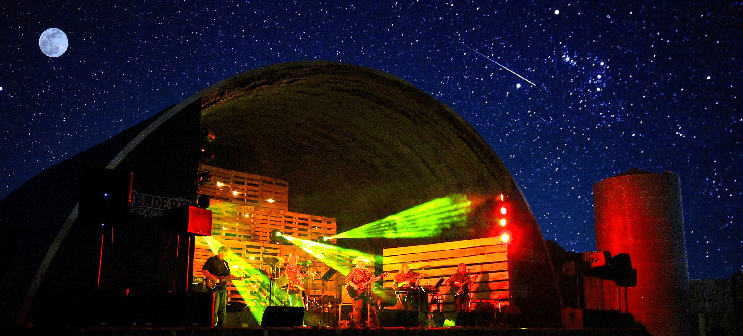Open ended Quonset lit up at night