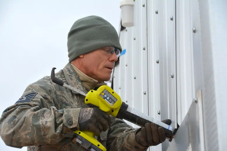 Reserve engineer putting the finishing touches on a Quonset hut at Oklahoma Air Force Base.