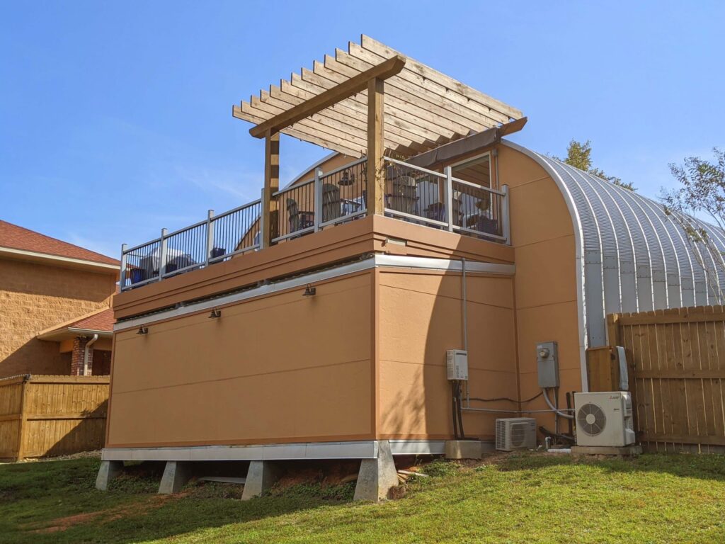 back patio with awning of orange quonset aparment