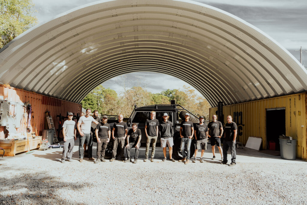 group of people in front of jeep and container cover