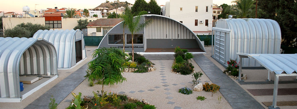 All Quonset hut models surrounding a Q-Model Quonset hut