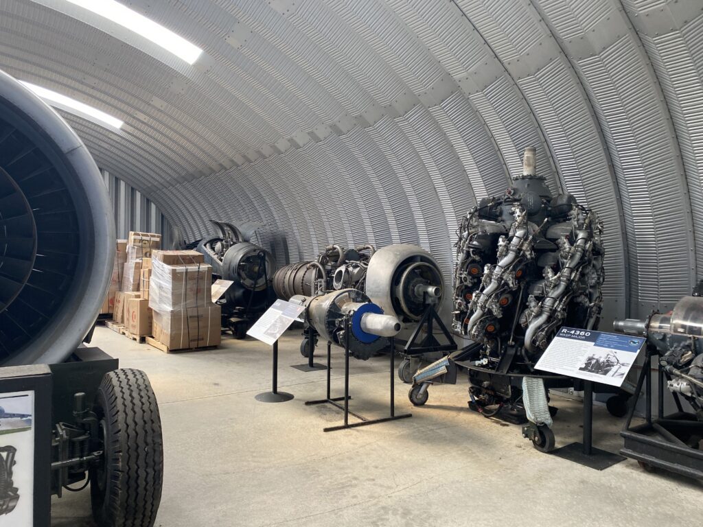 Inside of steel arched museum, metal endwall, aircraft engines