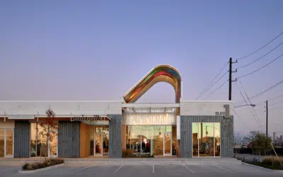 decorative steel arch awning over store entrance with locally painted murals underneath.