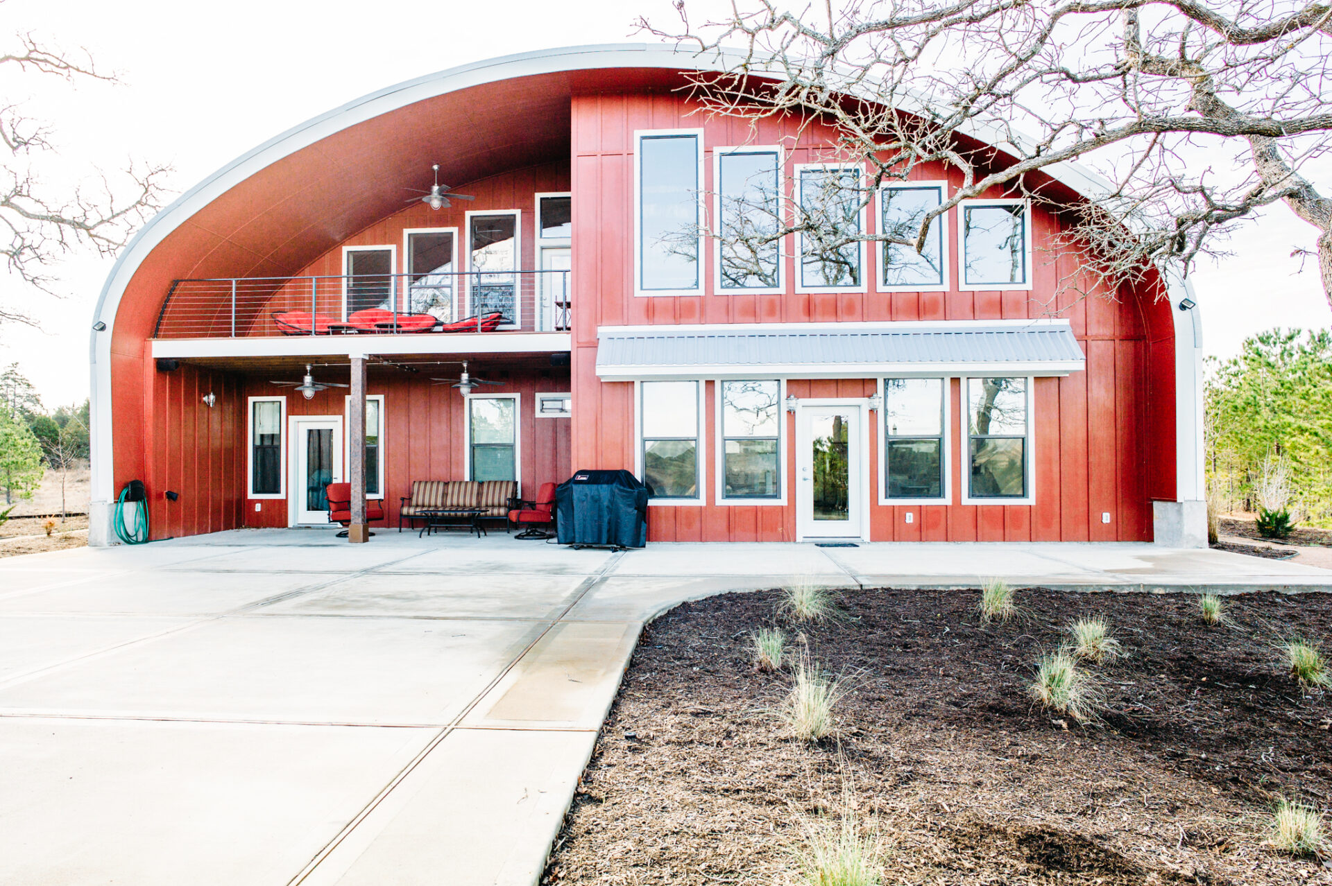 S-Model Quonset home with custom red front end wall